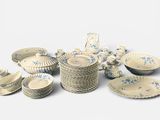a lot of plates and bowls sitting on a table