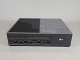 a close up of a black computer on a white surface