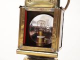 a small brass lantern with a glass inside of it