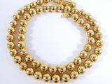 two strand bracelet with gold beads and a gold clasp
