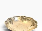 a gold plate with a flower design on it