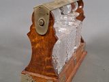 a glass block on a wooden stand with a metal handle