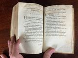 someone is reading a book on a table with their hands on it