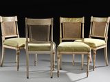 three chairs with cane back cushions and a cane back seat