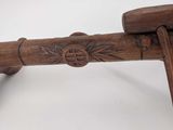 an image of a wooden bench with a wooden handle on top of it