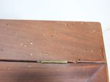 a wooden box with holes in it on a table