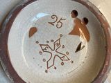 a white plate with a brown design on it