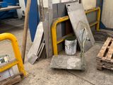 several pieces of metal are stacked on pallets in a warehouse