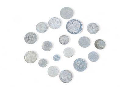 a lot of coins arranged in a circle on a white surface