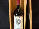 a bottle of wine in a wooden box on a black background
