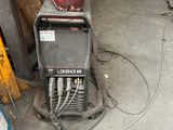 an image of a welding machine in a garage with other equipment