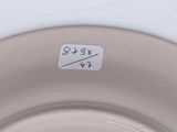 a white plate with a sticker on it that says $ 9 95
