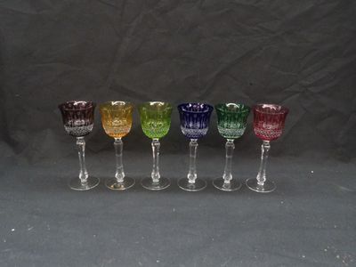 six different colored wine glasses are lined up in a row