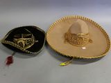 two hats that are sitting next to each other on a table