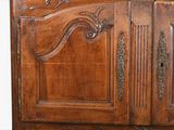 a large wooden cabinet with a mirror on top of it