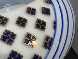 a lot of blue and white plates with gold crosses on them