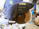 someone is using a circular saw to cut a piece of wood