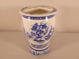 a blue and white vase sitting on a table
