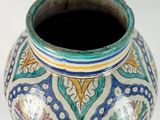 a vase with a lid sitting on a white surface