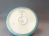a blue and white plate on a gray surface