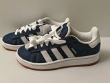 a pair of blue and white sneakers on a white surface