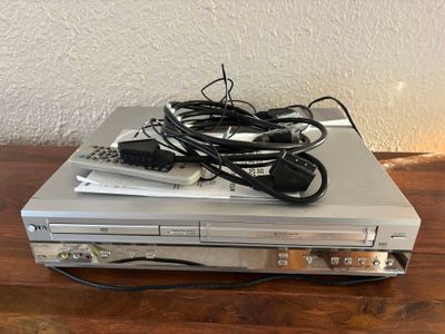 a dvd player sitting on top of a wooden table