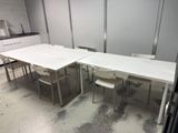 a table and chairs in a room with a refrigerator