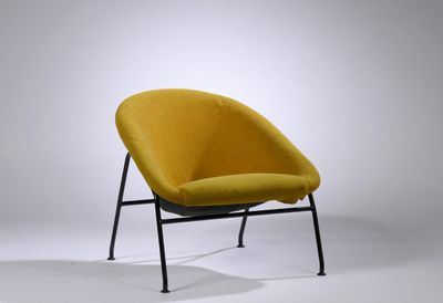 une chaise jaune aux pieds noirs et à l'armature noire