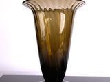 a glass vase sitting on a table with a white background