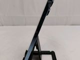 a tablet that is sitting on a stand on a table