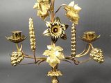 brass candelier with flowers and leaves on a stand
