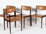 three wooden chairs with brown leather seats against a white wall