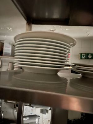 many plates stacked on top of each other in the kitchen