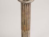 pair of antique silver candlesticks on a silver background
