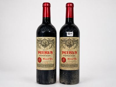 two bottles of red wine sitting next to each other on a white surface
