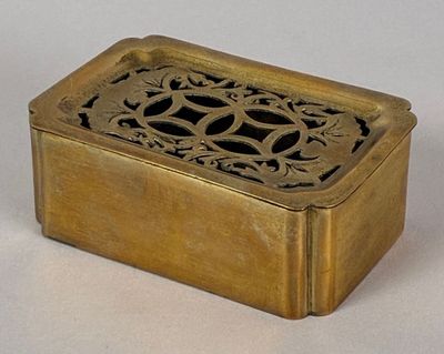 a small brass box with a decorative design on it