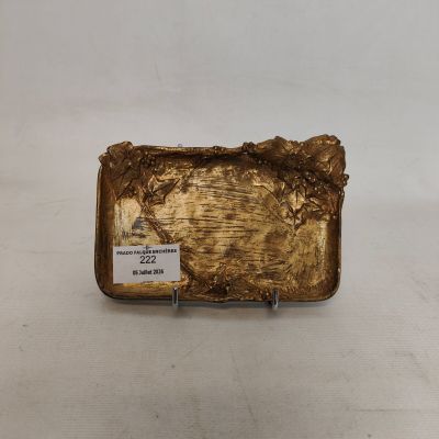 an image of a gold plate on a white surface