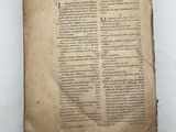 a close up of an old book on a white surface