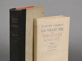 two books sitting next to each other on a gray surface