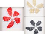 three framed pictures of four different colored paper flowers in a white frame