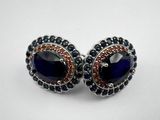 a pair of earrings with blue and red stones