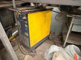 a yellow machine that is sitting in the middle of a room