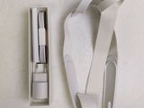 a white box with a pair of scissors and a pair of scissors in it