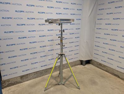 a microphone on a tripod in front of a wall