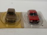 three toy cars sitting on top of each other on a table