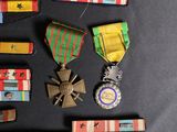 many medals and pins laid out on a table