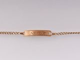 a close up of a gold bracelet with a clasp on a white background