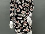 a mannequin wearing a black and white dress with playing cards on it