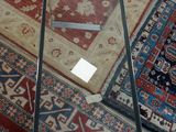 many rugs on the floor in a room
