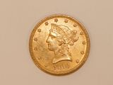 a close up of a gold coin with a woman ' s head on it